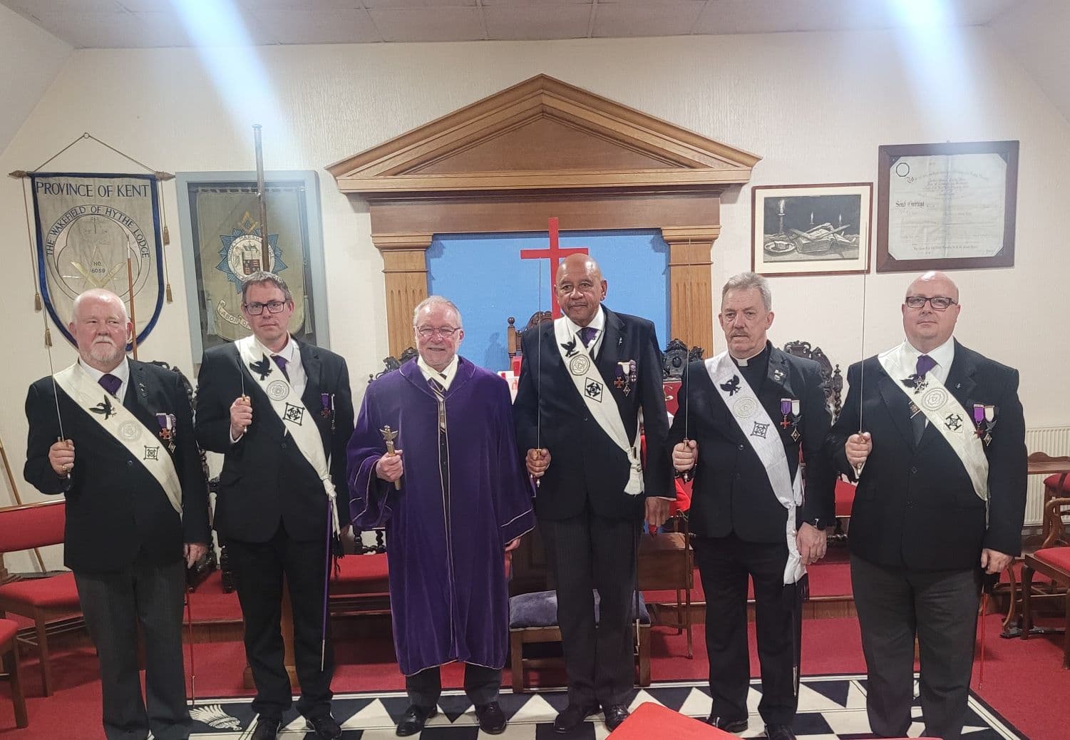 Members of the Sepulchre Guard in ceremonial dress within a Masonic meeting room.